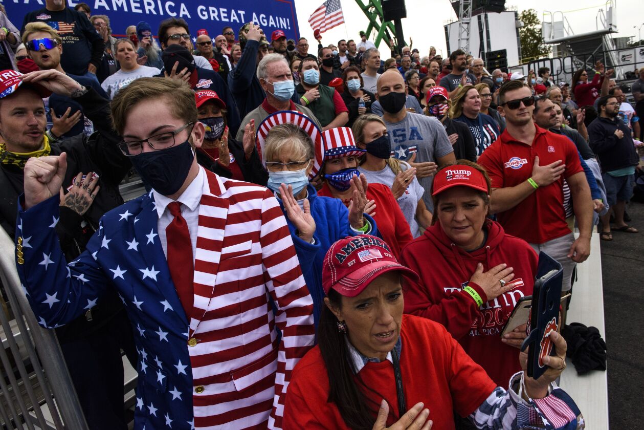 Crowd members cheer toward cameras before the arrival of President Donald Trump to a Make America Great Again rally on September 19, 2020 in Fayetteville, North Carolina.